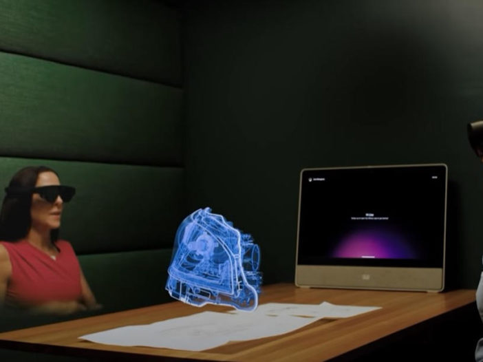 Una reuniñón de trabajo con un holograma como objeto de trabajo